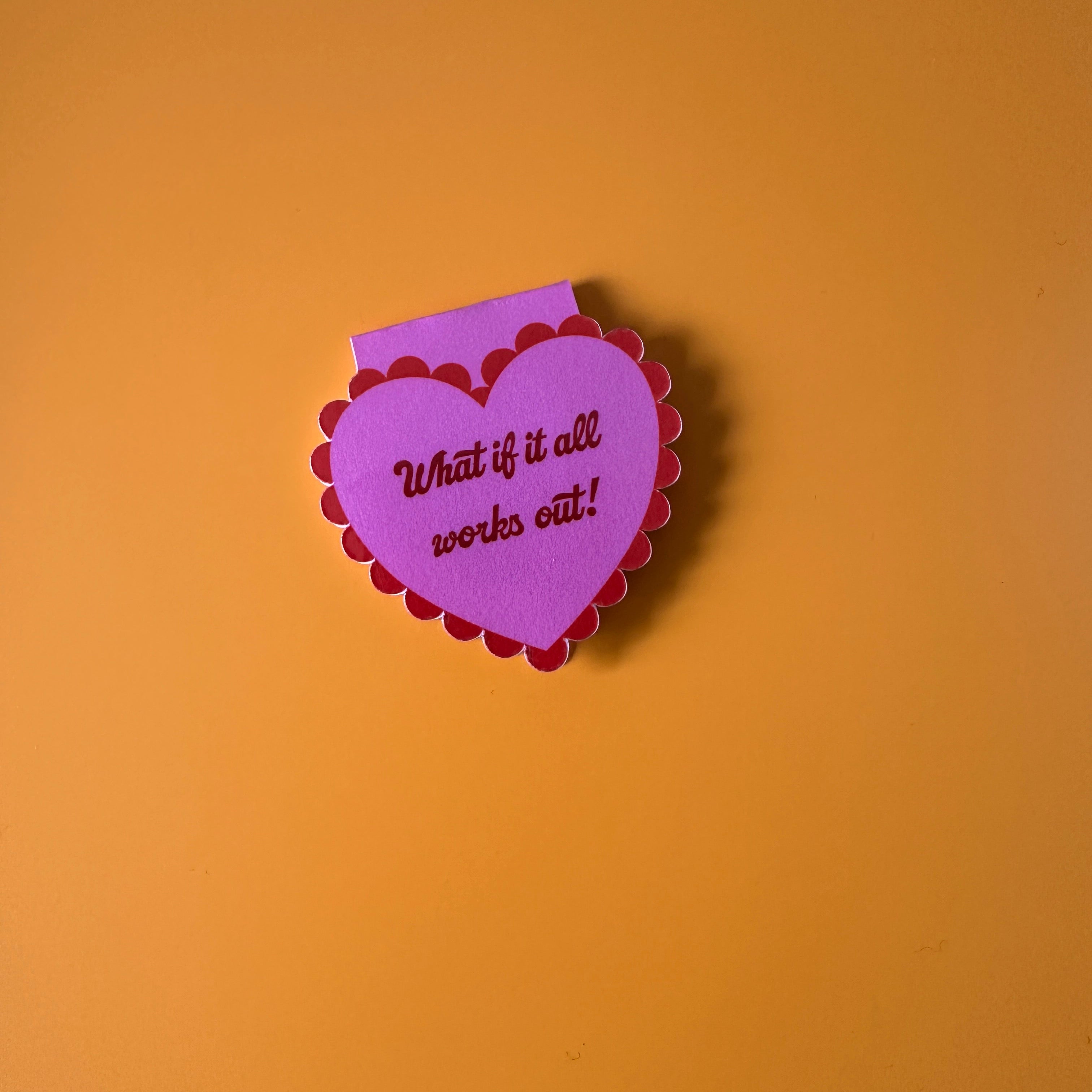 "Mauve scalloped heart corner bookmark with pink trim and the hand-lettered affirmation 'What if it all works out!'"