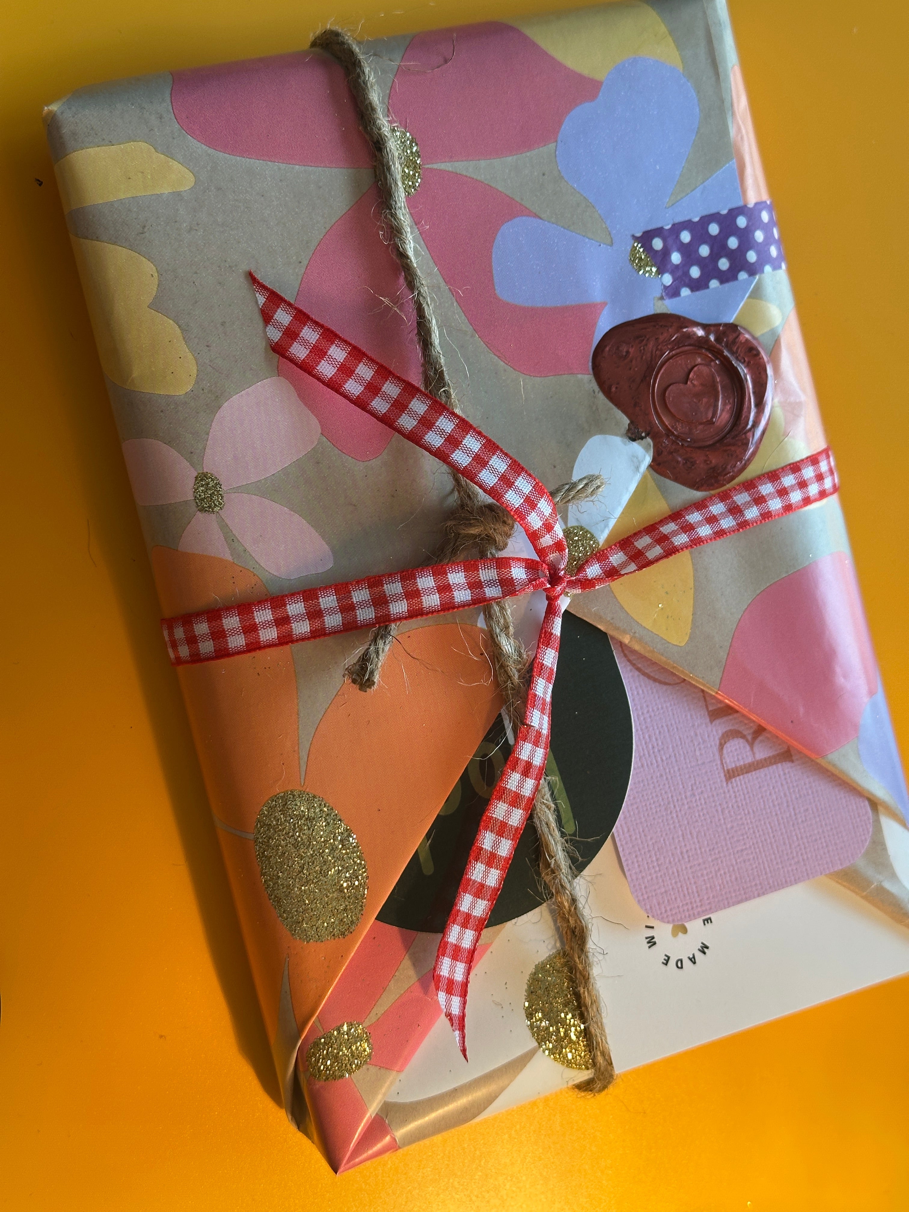 Stack of wrapped Blind Date with a Book mystery bundles in assorted genre wraps