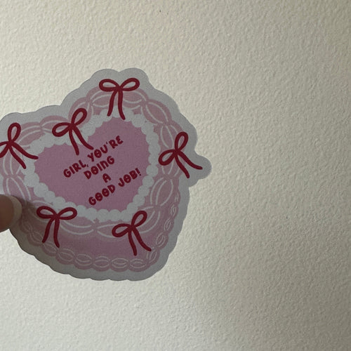 Close-up of the red bow border on the Girl You're Doing a Good Job sticker