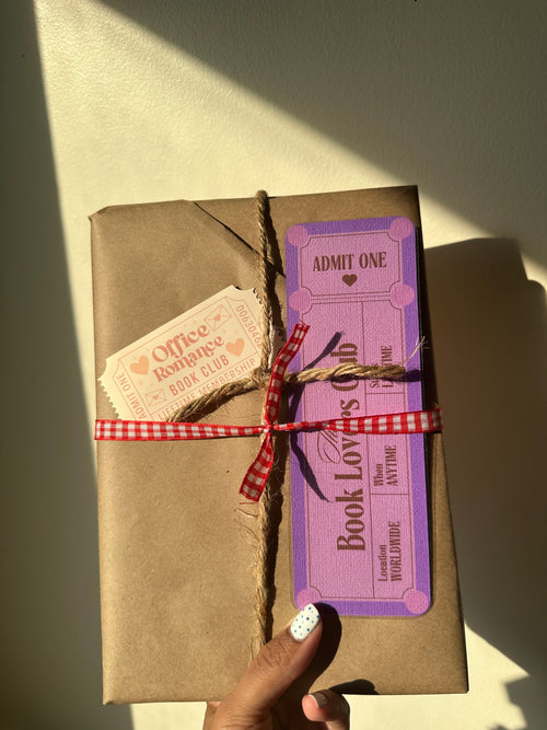 Blind Date with a Book wrapped in brown kraft paper and tied with twine, with a genre clue tag attached
